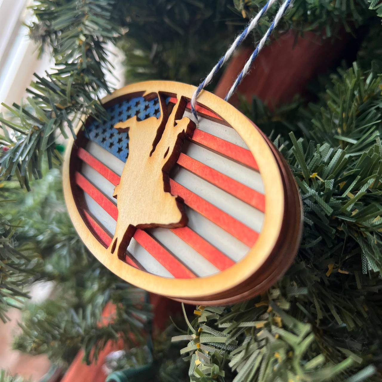 Patriotic Bull Rider Ornament – 4" Oval Wood Rodeo Christmas Ornament with American Flag Background for Cowboy & Western Decor