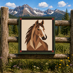 A framed square art print featuring a geometric brown horse head illustration, displayed on a rustic wooden fence with a mountain and forest landscape in the background.