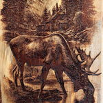 Wooden plaque with a moose and mountain landscape engraving