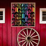 Feather Barn Quilt Pattern displayed on a rustic red barn with a vintage wagon wheel, showing the finished painted barn quilt outdoors.