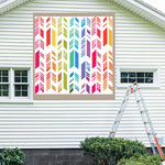 Feather Barn Quilt Pattern displayed on the exterior of a farmhouse, illustrating how the finished painted quilt block looks on a home.