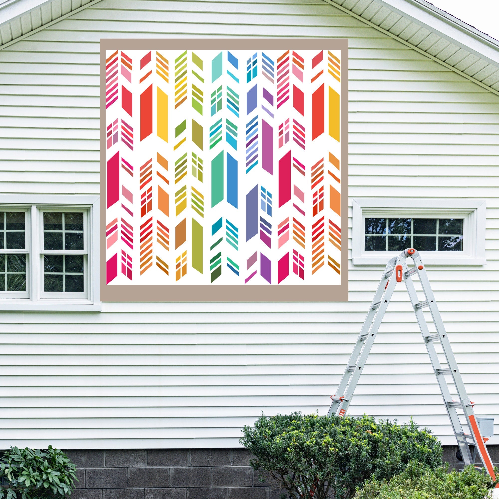 Feather Barn Quilt Pattern displayed on the exterior of a farmhouse, illustrating how the finished painted quilt block looks on a home.