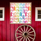 Feather Barn Quilt Pattern displayed on a rustic red barn with a vintage wagon wheel, showing the finished painted barn quilt outdoors.