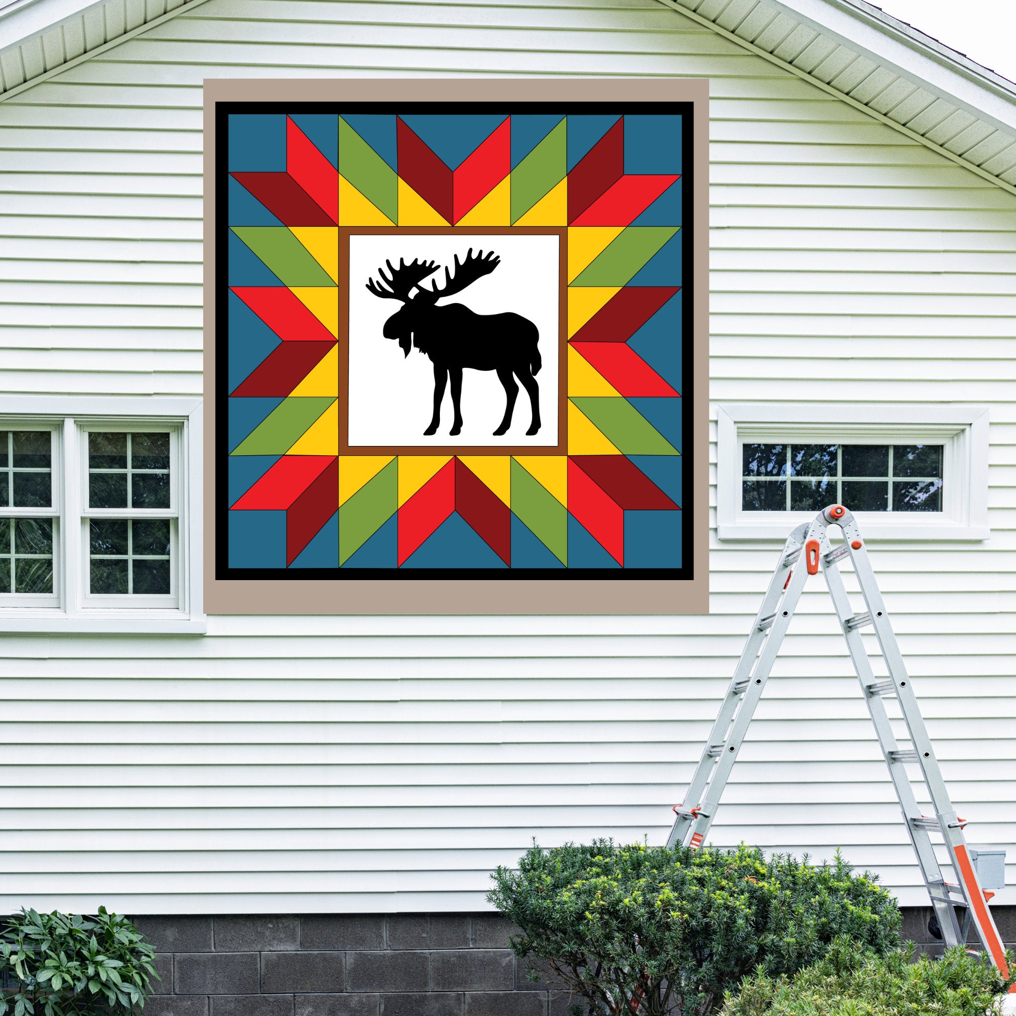 Moose in the Wild Barn Quilt Pattern displayed on the exterior of a farmhouse, illustrating how the finished painted quilt block looks on a home.