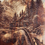Wooden carving of a moose, cabin, and mountain landscape