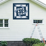 Pinwheel Knot  Barn Quilt Pattern displayed on the exterior of a farmhouse, illustrating how the finished painted quilt block looks on a home.