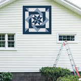 Pinwheel Knot  Barn Quilt Pattern displayed on the exterior of a farmhouse, illustrating how the finished painted quilt block looks on a home.