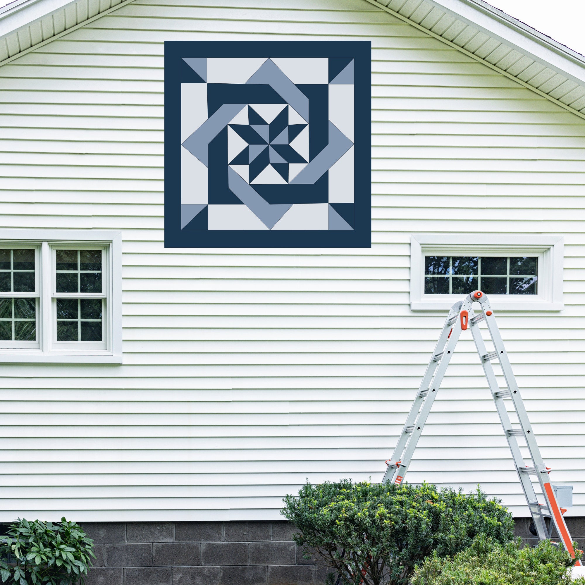 Pinwheel Knot  Barn Quilt Pattern displayed on the exterior of a farmhouse, illustrating how the finished painted quilt block looks on a home.
