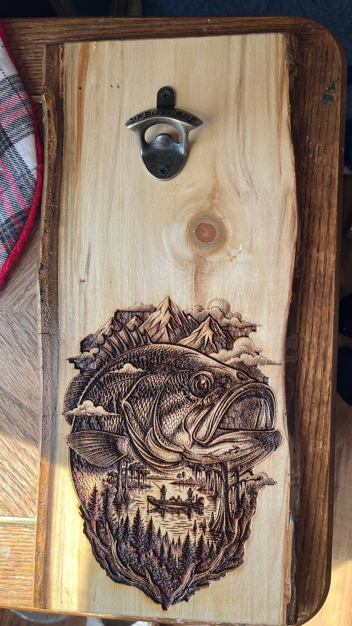 Wooden cutting board with a fish design and bottle opener on a wooden surface.