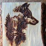 Wooden plaque with a burned design of a dog's head on a wooden surface