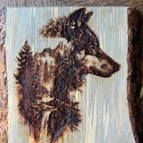 Wooden plaque with a burned design of a dog's head on a wooden surface