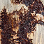 Wooden carving of two wolves with a forest background