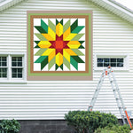 Sunflower Barn Quilt Pattern displayed on the exterior of a farmhouse, illustrating how the finished painted quilt block looks on a home.