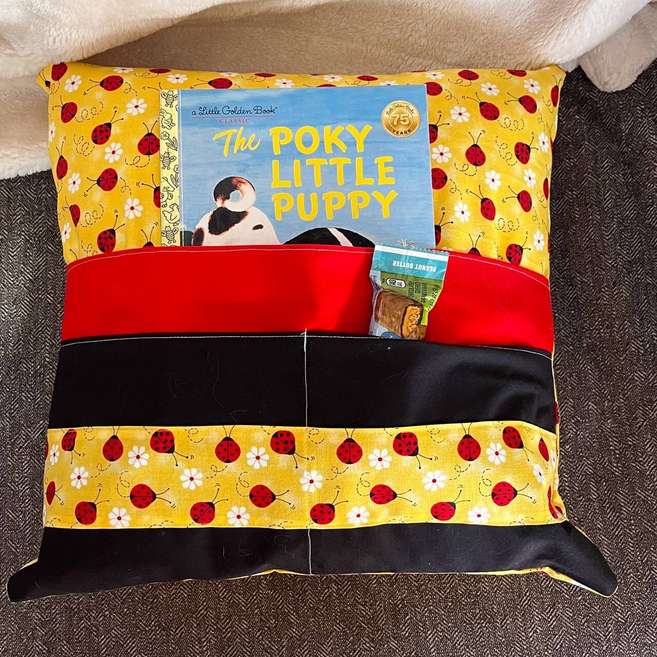 Yellow reading pillow with double front pocket