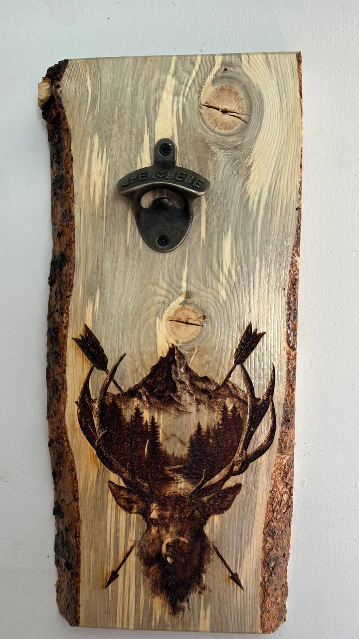 Wooden bottle opener with a deer design on a light gray background