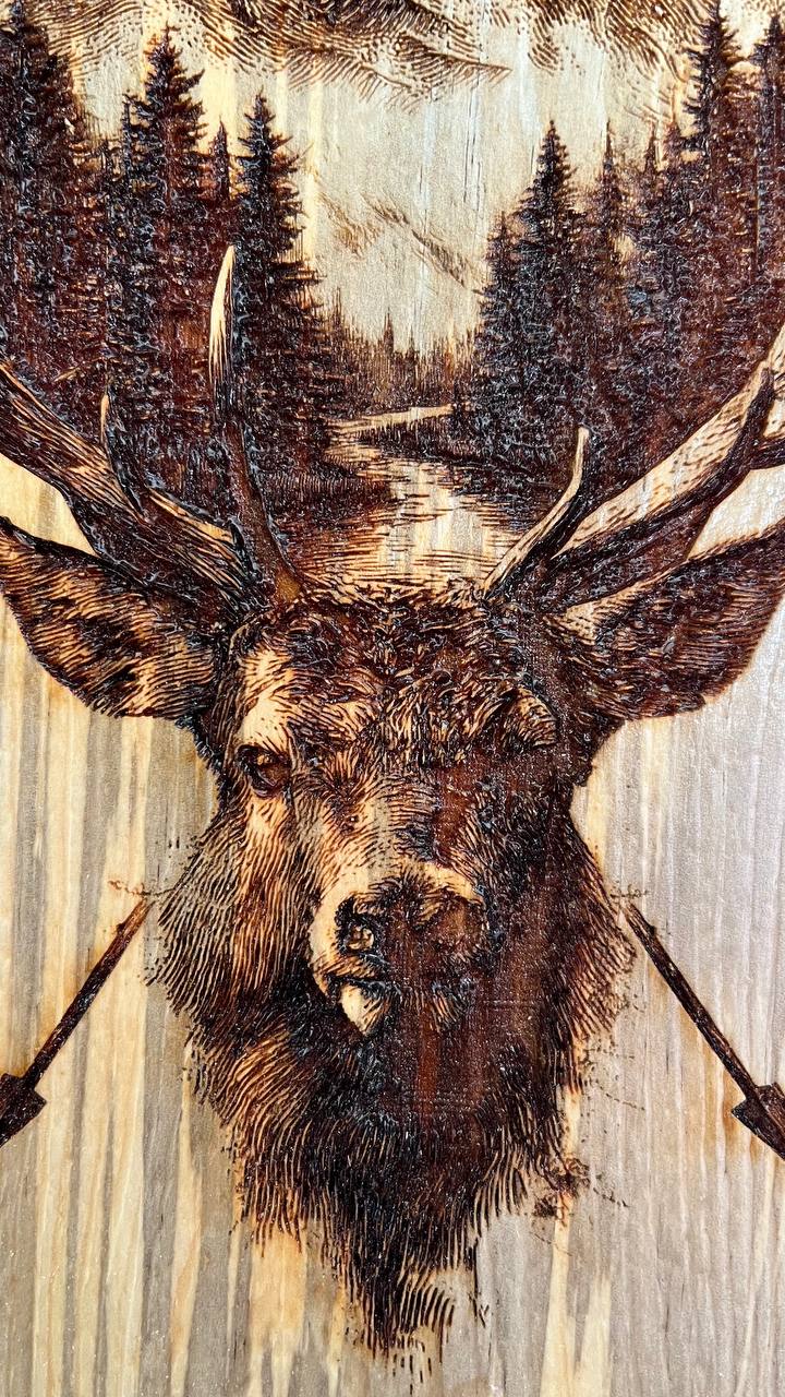 Wooden texture with a deer head carving and forest background