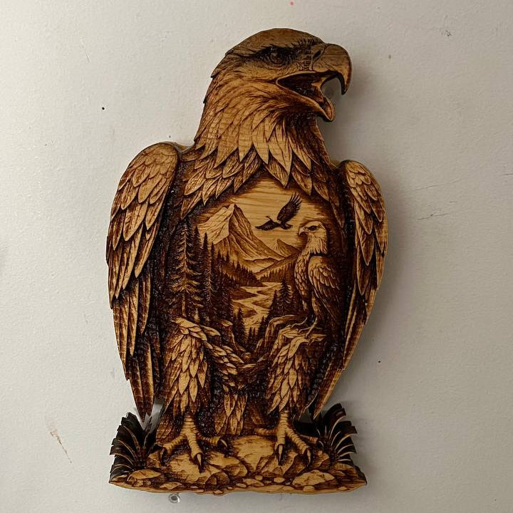 Wooden carving of an eagle on a white wall