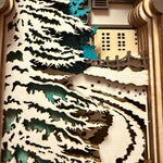 Handmade wooden Christmas book nook featuring a layered winter church, snow-covered evergreen trees and moonlit landscape for rustic Christmas bookshelf decor.