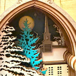 Handmade wooden Christmas book nook featuring a layered winter church, snow-covered evergreen trees and moonlit landscape for rustic Christmas bookshelf decor.